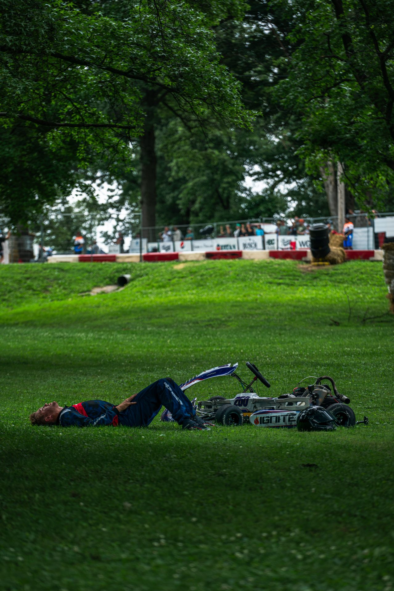 Owen Neisel lying in the grass next to his kart