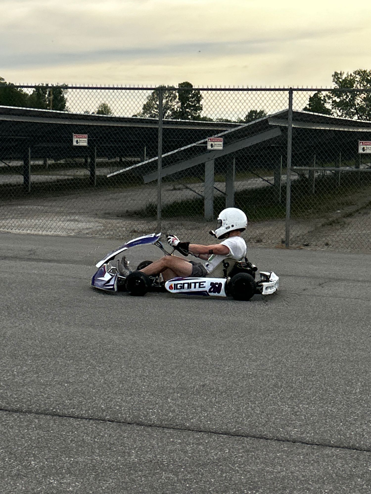 Owen Neisel testing his kart in a parking lot during a test day