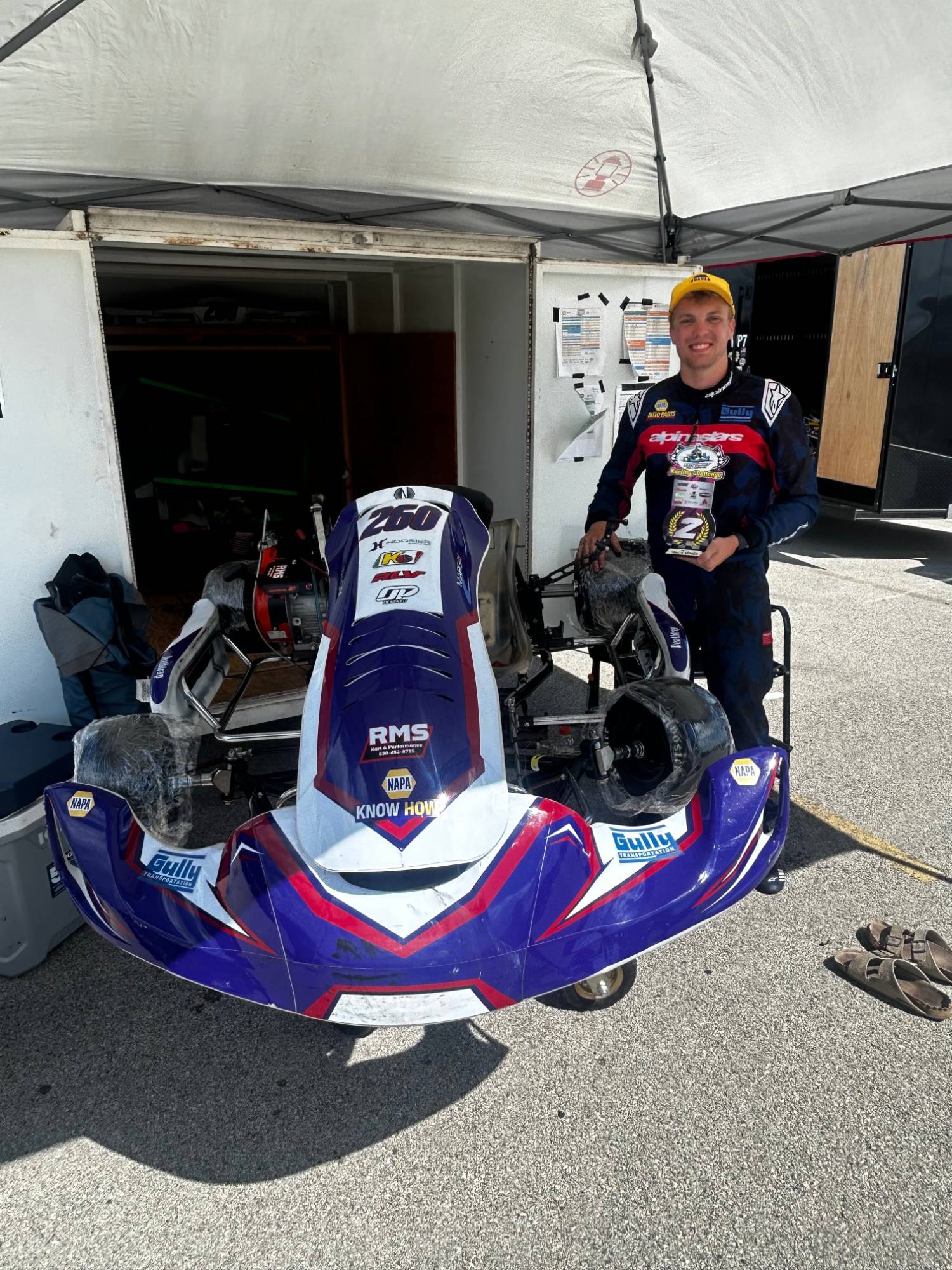 Owen Neisel holding his second place trophy at Round 2