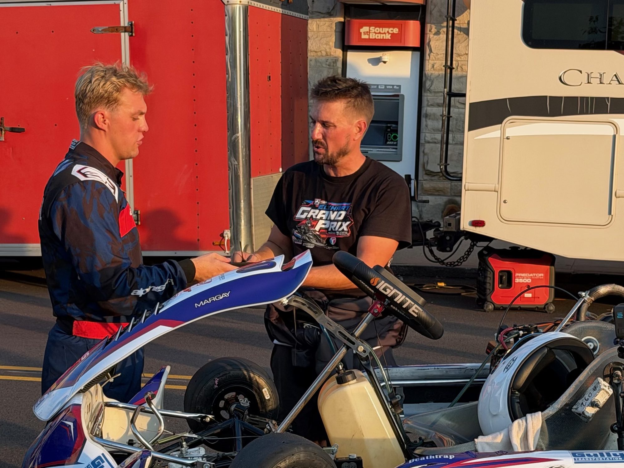 Owen Neisel talking with a sponsor at the Elkhart Grand Prix